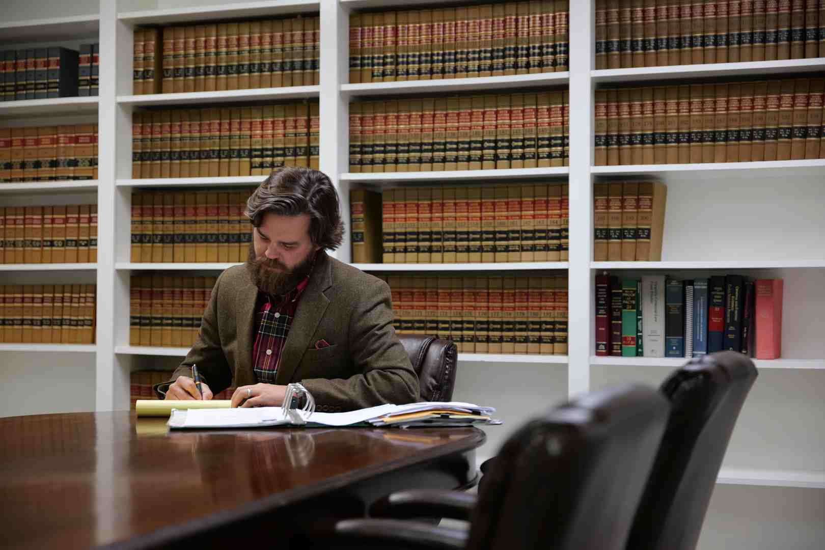 person reviewing medical bills and a calendar showing missed work days - Injury claim settlement person reviewing medical bills and a calendar showing missed work days - Injury claim settlement