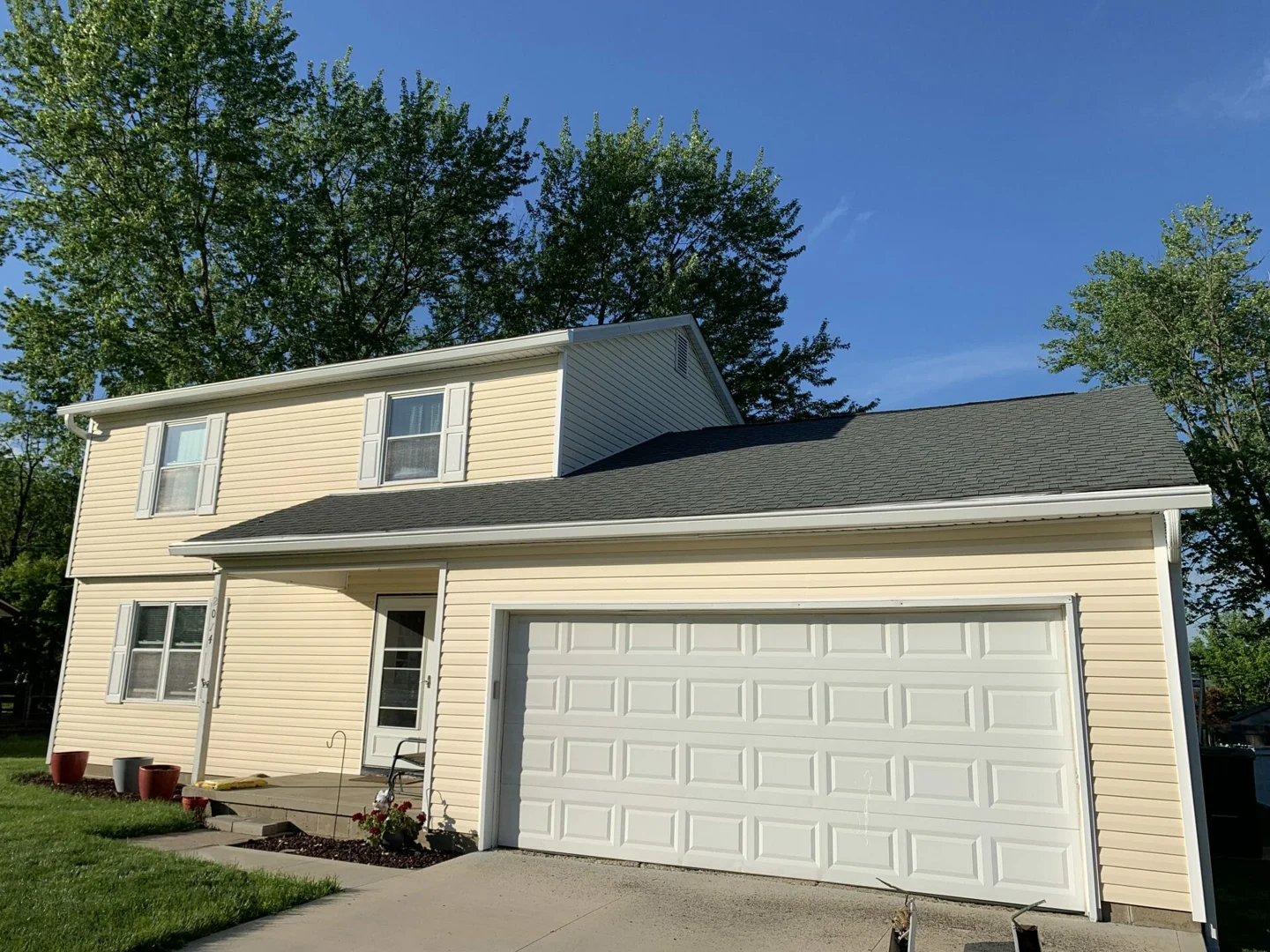 a complex multi-story roofline requiring professional gutter installation - what do new gutters cost