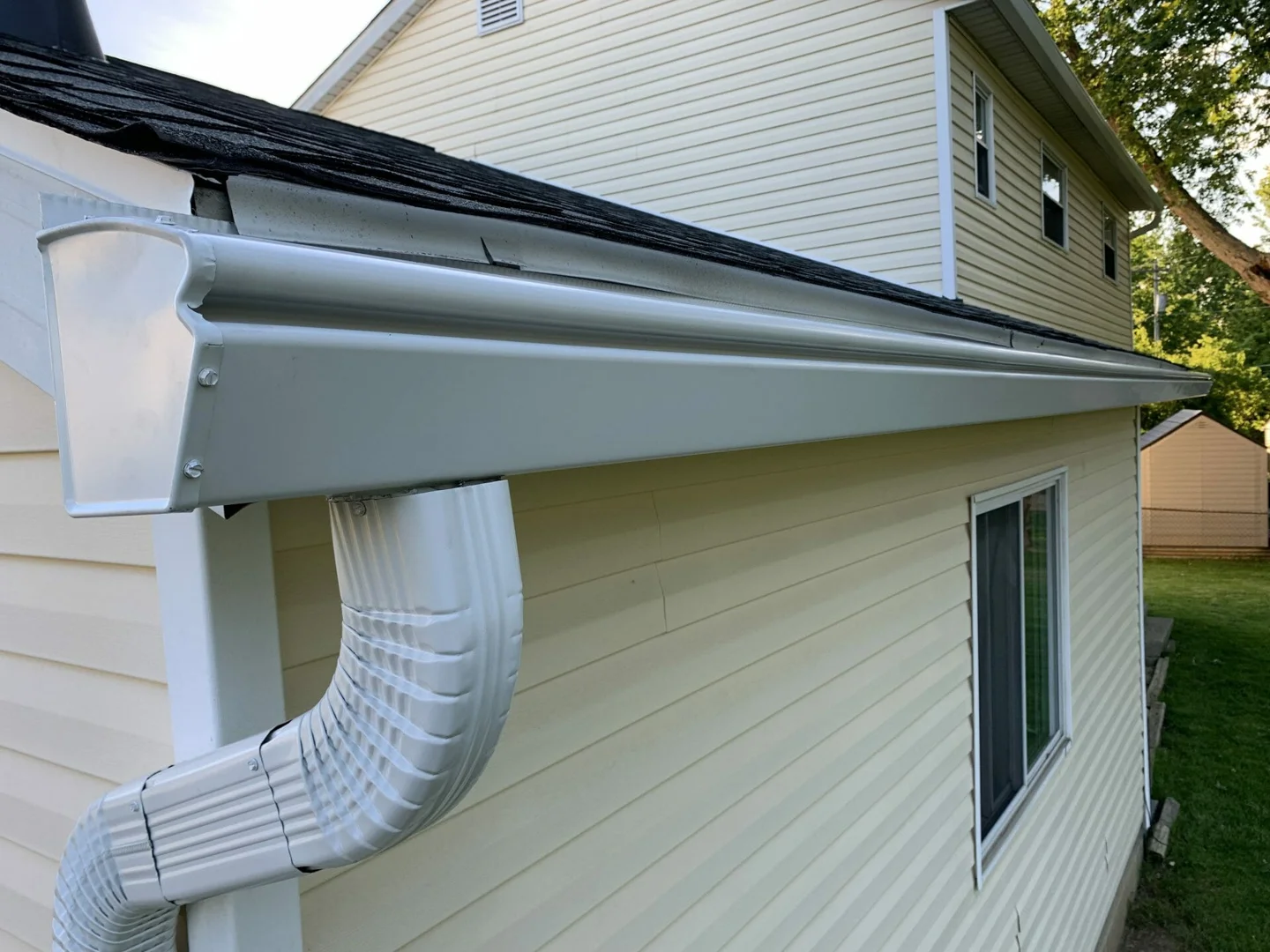 A complex roofline with multiple gables and levels requiring professional gutter installation - cost of new gutters