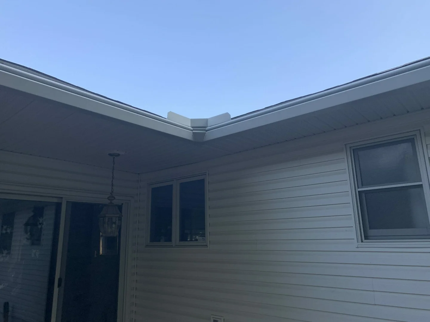 Close up of water flowing over a curved gutter hood illustrating surface tension - Never Clean Gutters Again