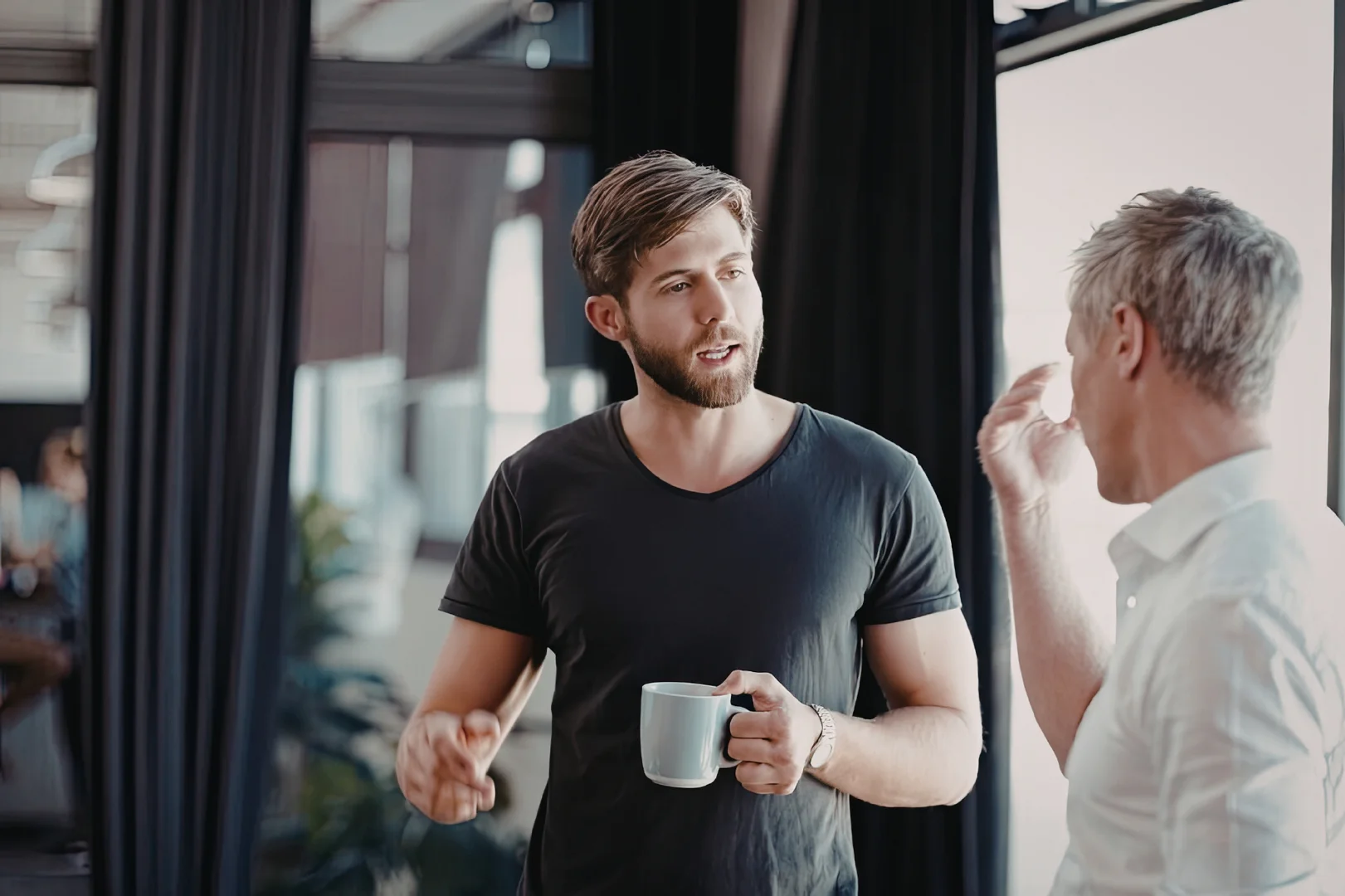 two men having a discussion during work. two men having a discussion during work.
