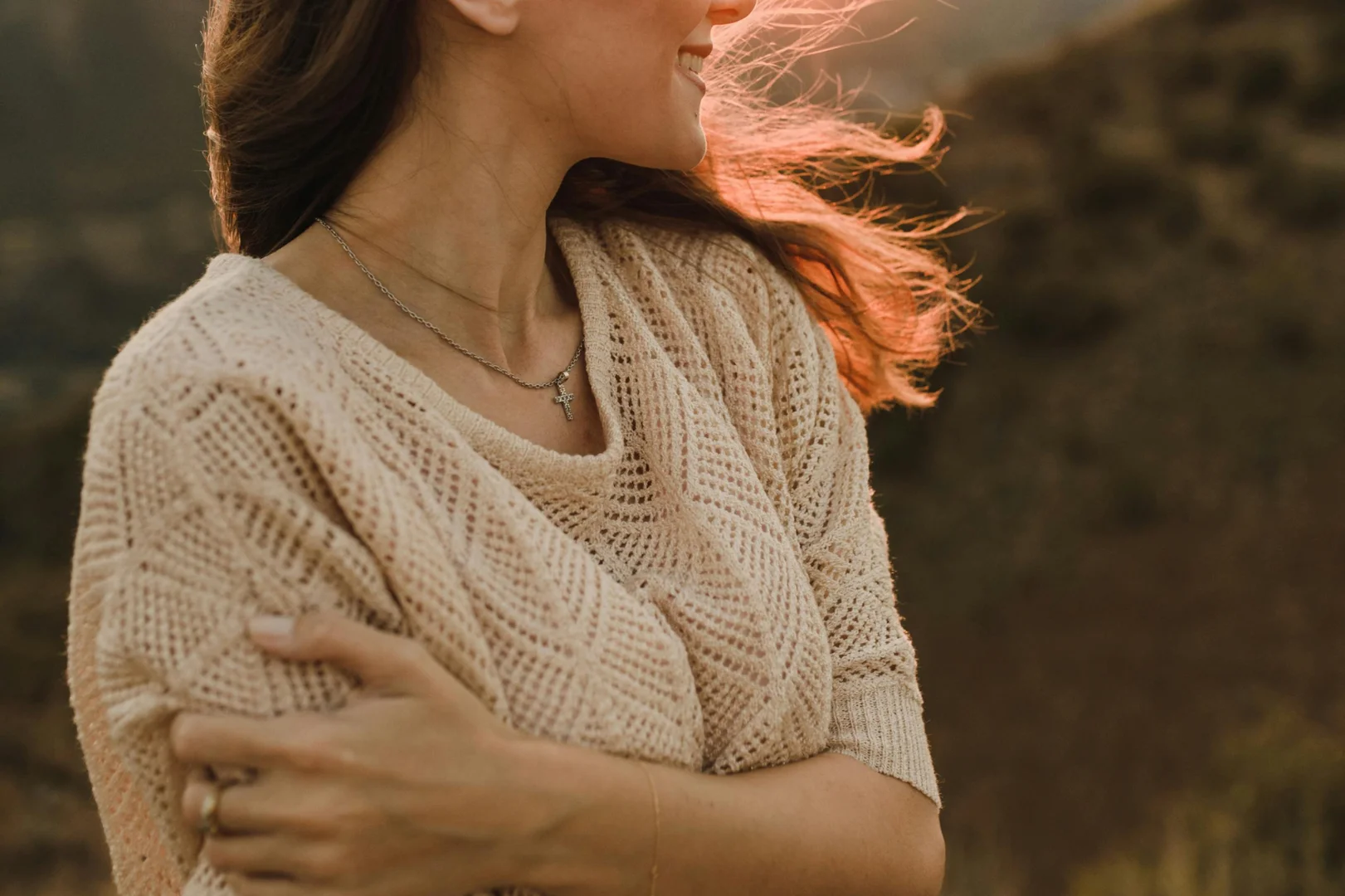 A highacheving women smiling in a wind- therapy overachievers mental health