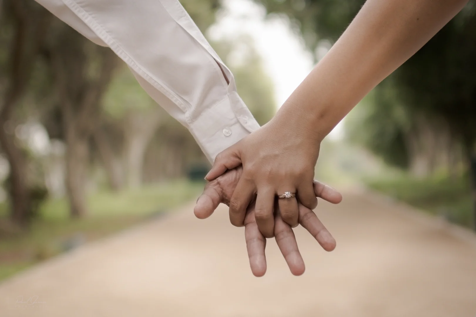 hands resting gently outdoor with green background hands resting gently outdoor with green background