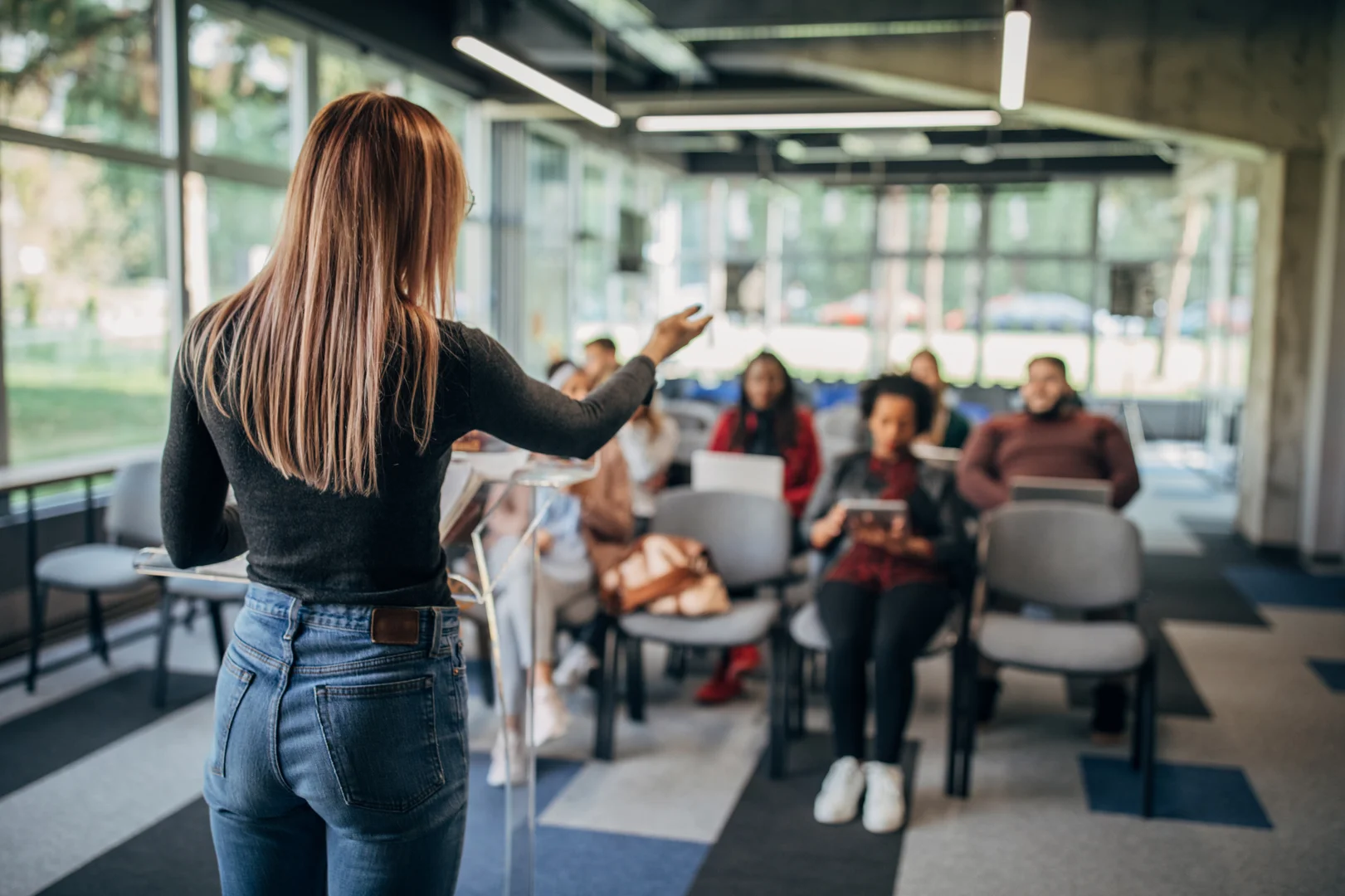 a woman giving a presentation in a office setting