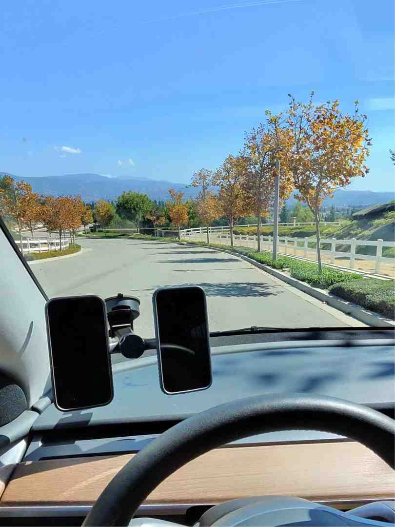 clean, minimalist desk with a LYNQQ quick release phone mount next to a cluttered desk with a bulky, traditional clamp mount - Quick release mount