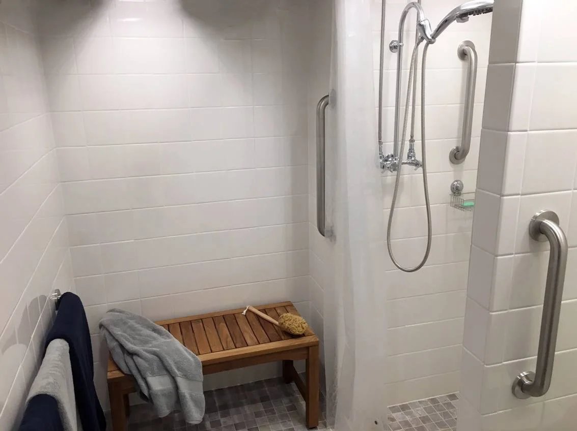 GOLDENTEAK's teak shower bench in an outdoor setting - shower seat for elderly
