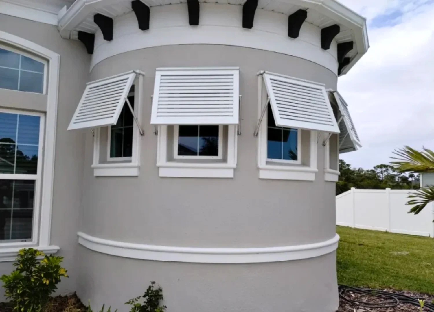 Bahama shutters providing exterior shade over residential windows Bahama shutters providing exterior shade over residential windows