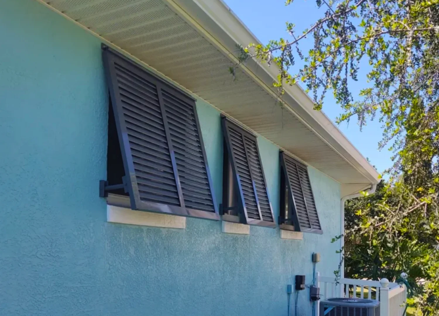 A beautifully installed, custom-fit Bahama shutter on a modern home A beautifully installed, custom-fit Bahama shutter on a modern home