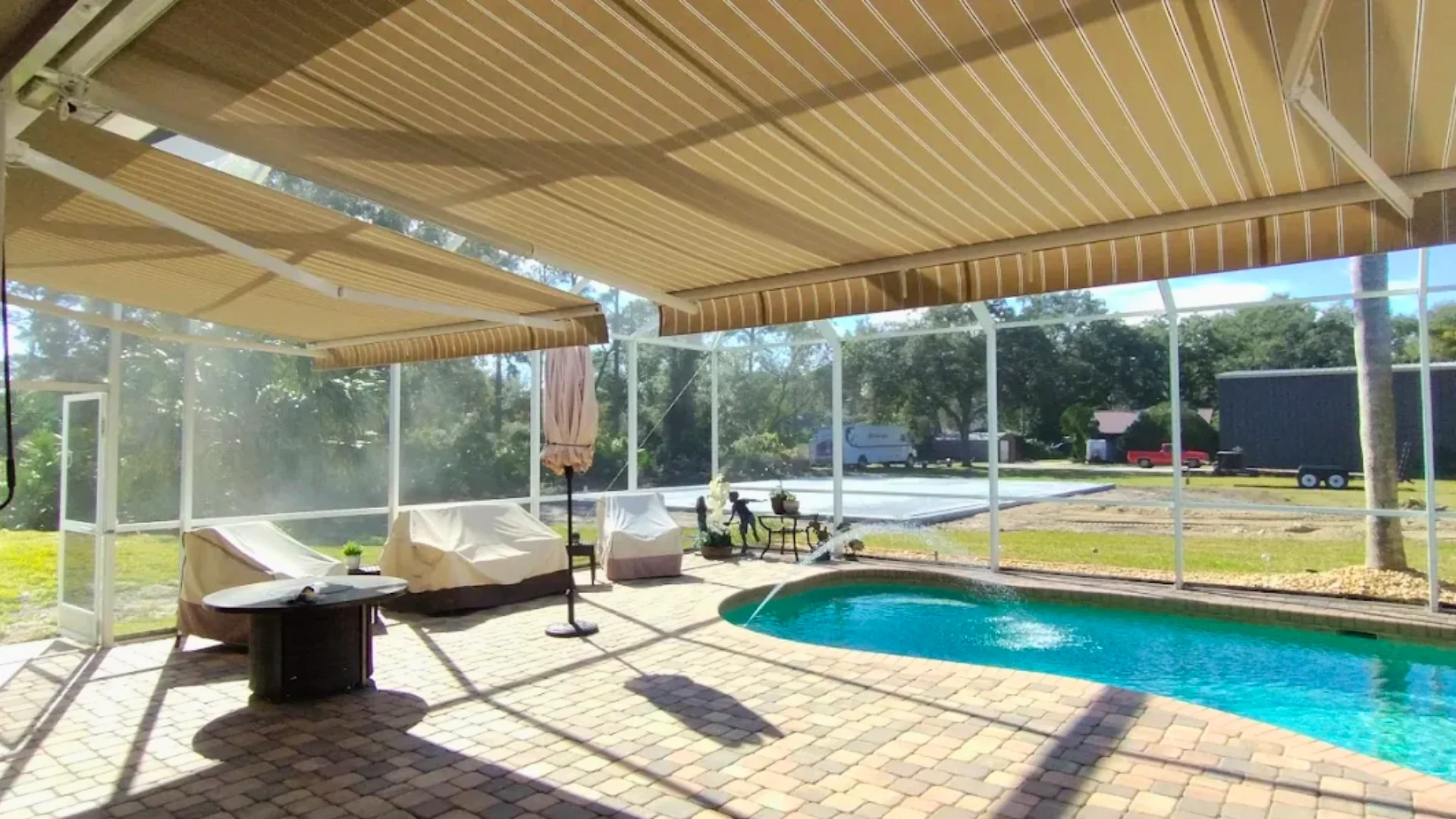 Retractable awning extended over a residential patio Retractable awning extended over a residential patio