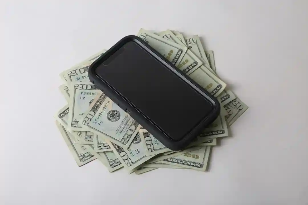 money and phone representing monetization opportunities - sponsored post opportunities
