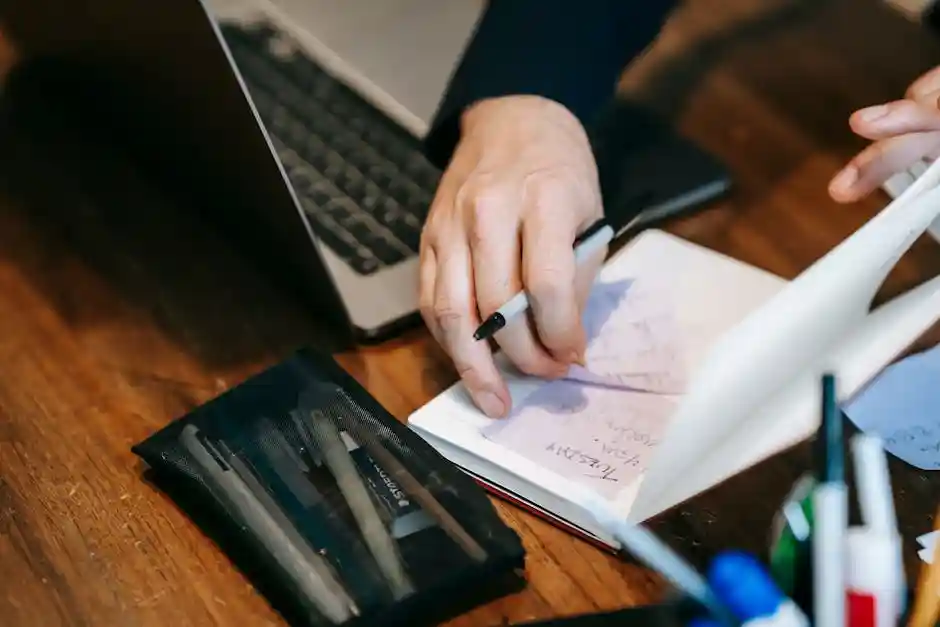 person planning side hustle with notebook and laptop - how to make money on the side