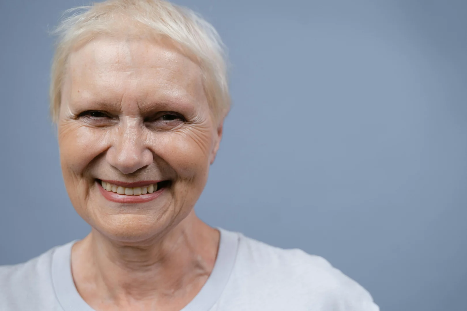 Smiling Woman in White Crew Neck Shirt