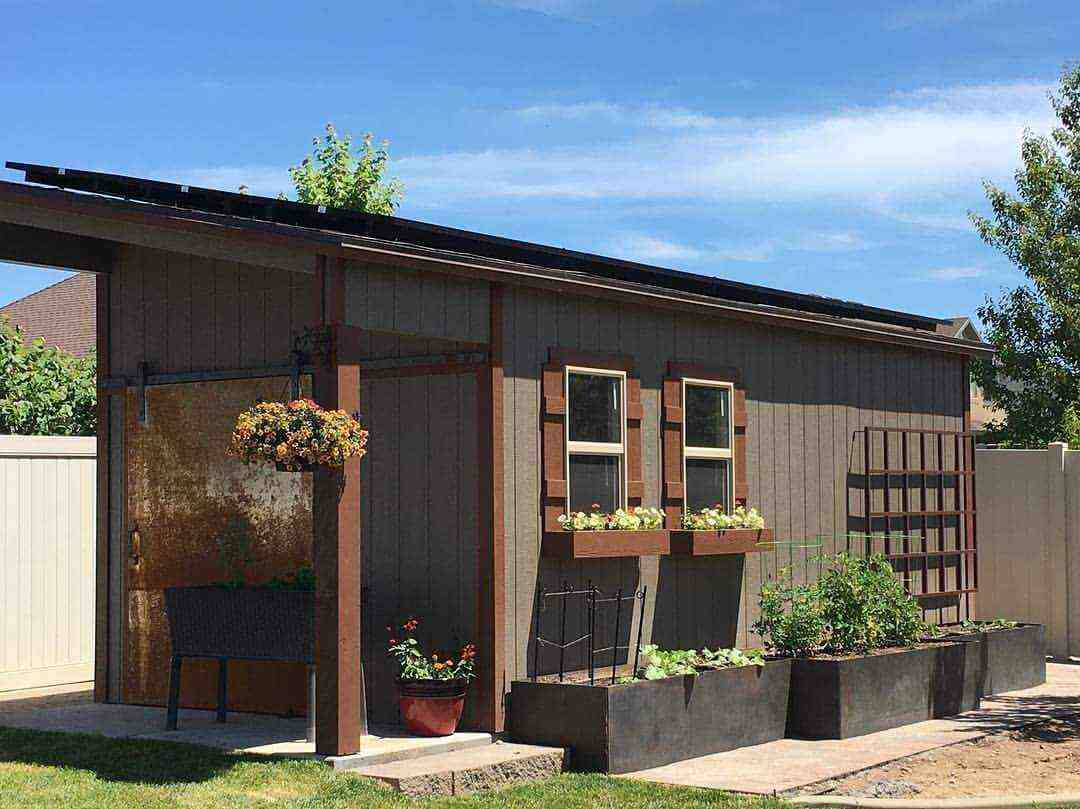 Modern garden storage shed for sale in Utah with planter boxes, trellis, and rustic charm.