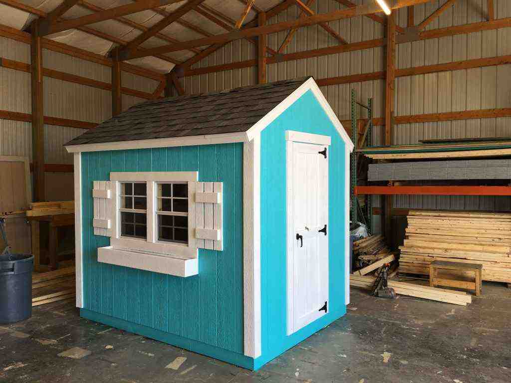Small blue and white structure ideal as backyard storage.