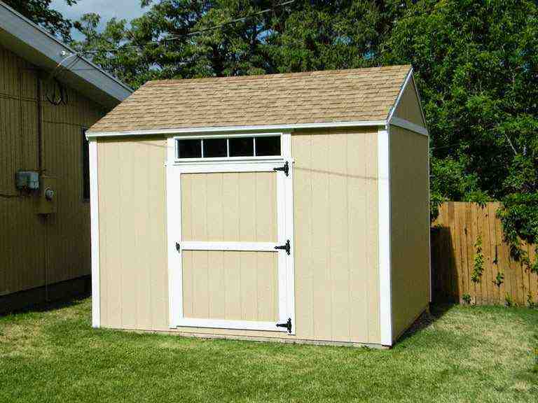 Finished DIY storage shed with a roof, window, and door, ready for use in your backyard project.