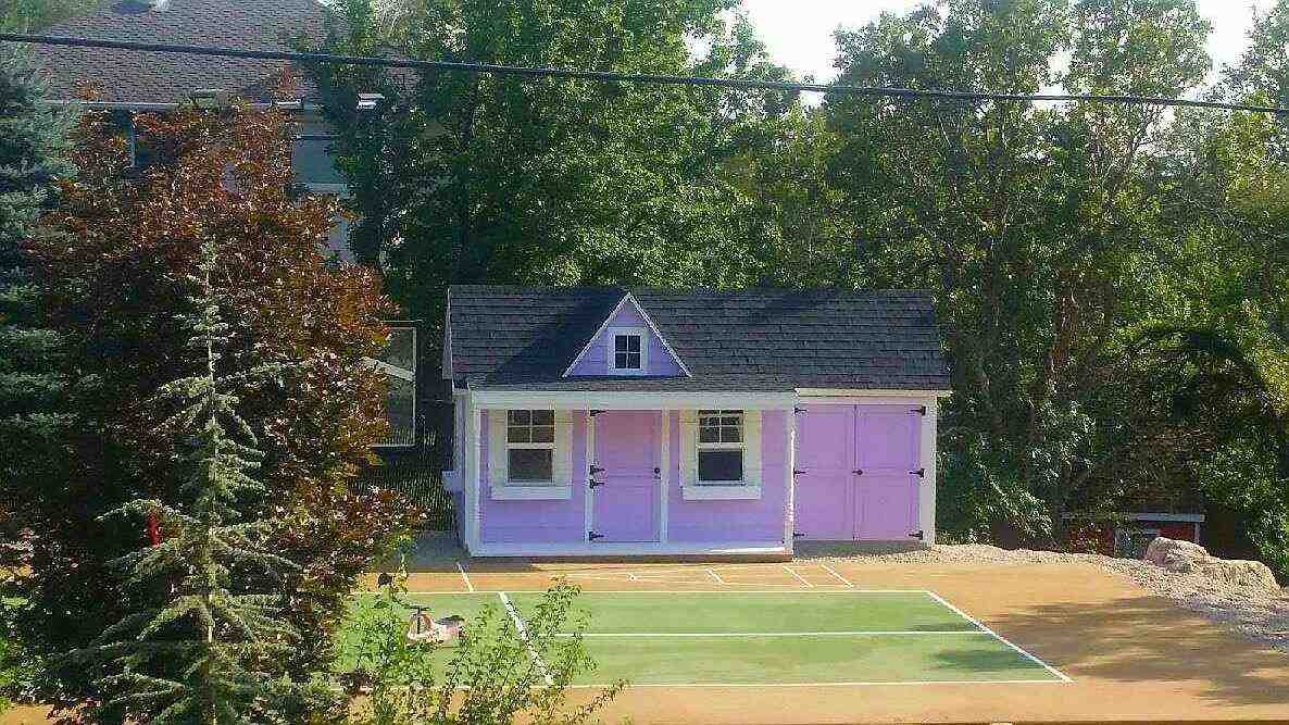 Lavender-painted playhouse with white trim and dark roof – expert playhouse painting in Farmington.