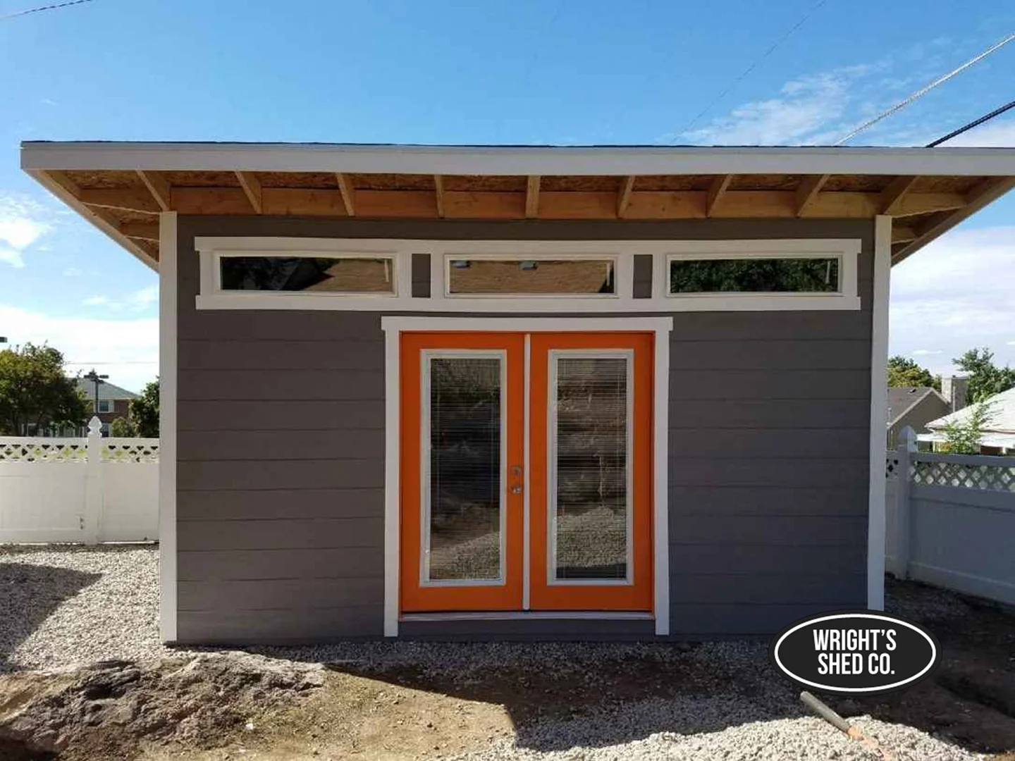 Modern Shed Design with Double Glass Doors Modern shed design featuring clean lines, sloped roof, and double glass doors with bright accents in a backyard setting