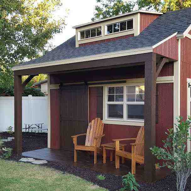 Cozy Backyard She Shed for Sale Backyard wooden she shed for sale with covered porch, red siding, and seating, designed as a relaxing outdoor retreat.