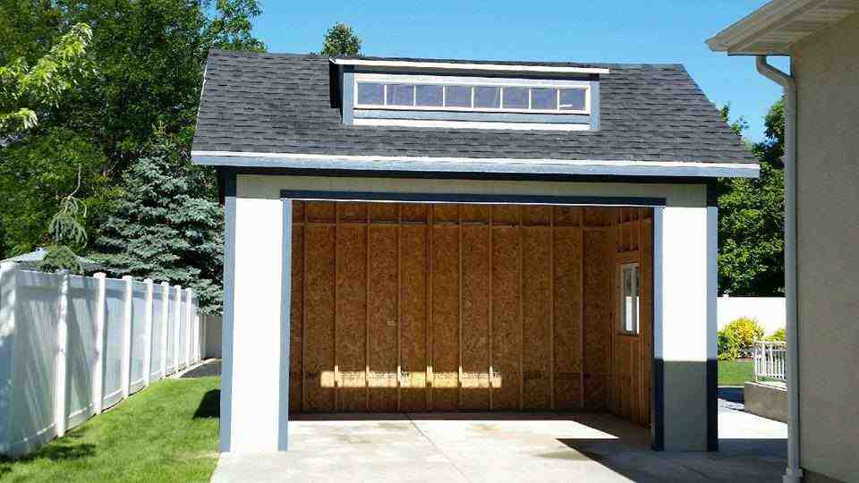 A custom detached garage with a unique design, featuring a large open space and skylight.