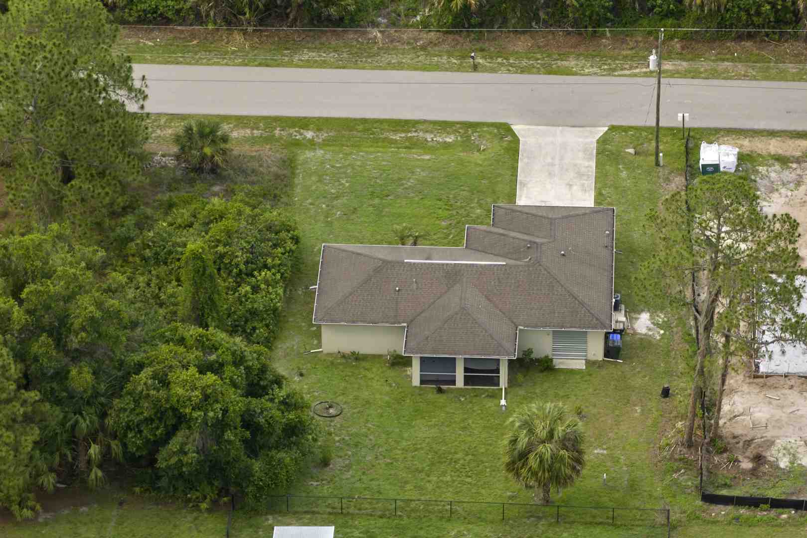 Professional drill crew installing PVC well casing with precision equipment on a residential property - water well drilling ohio Professional drill crew installing PVC well casing with precision equipment on a residential property - water well drilling ohio