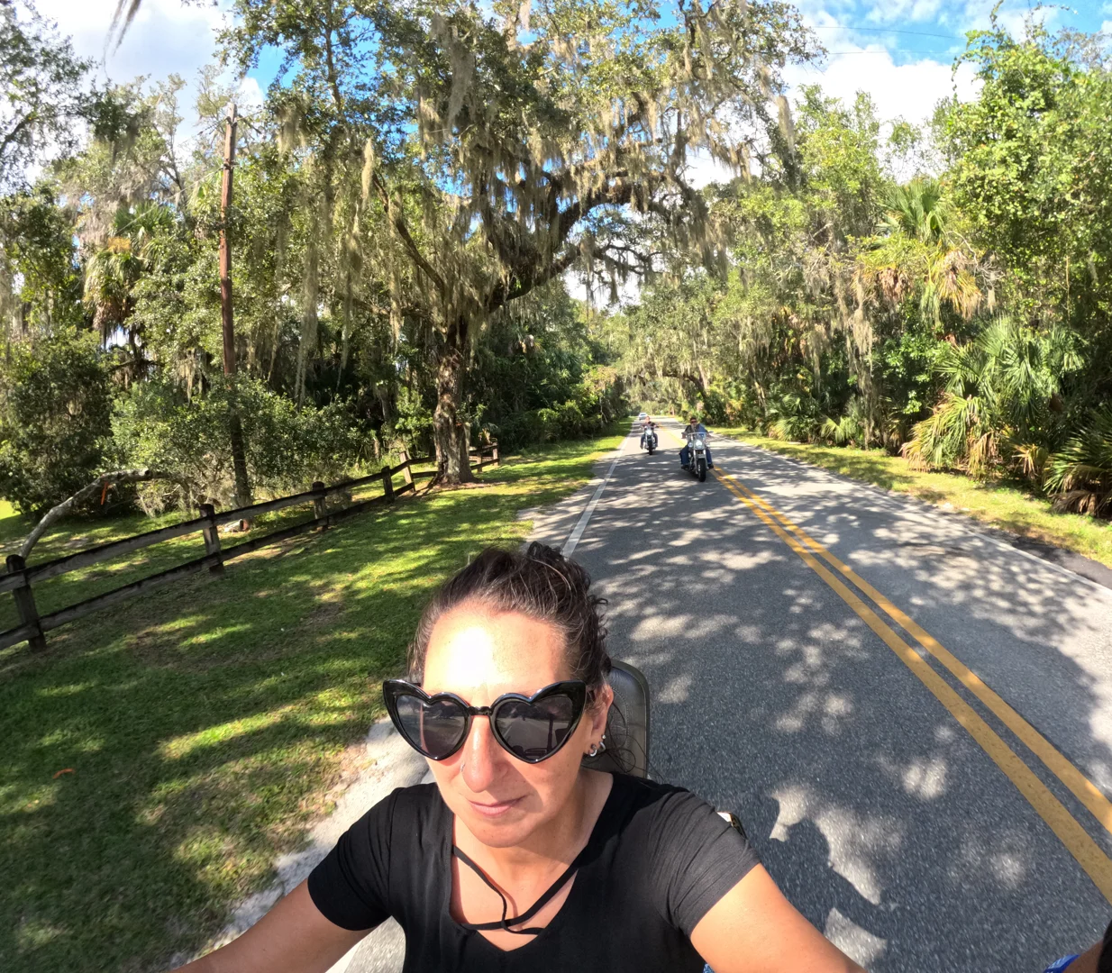 Group of bikers riding along a tree-canopied road on Florida's Nature Coast - crystal river motorcycle event calendar