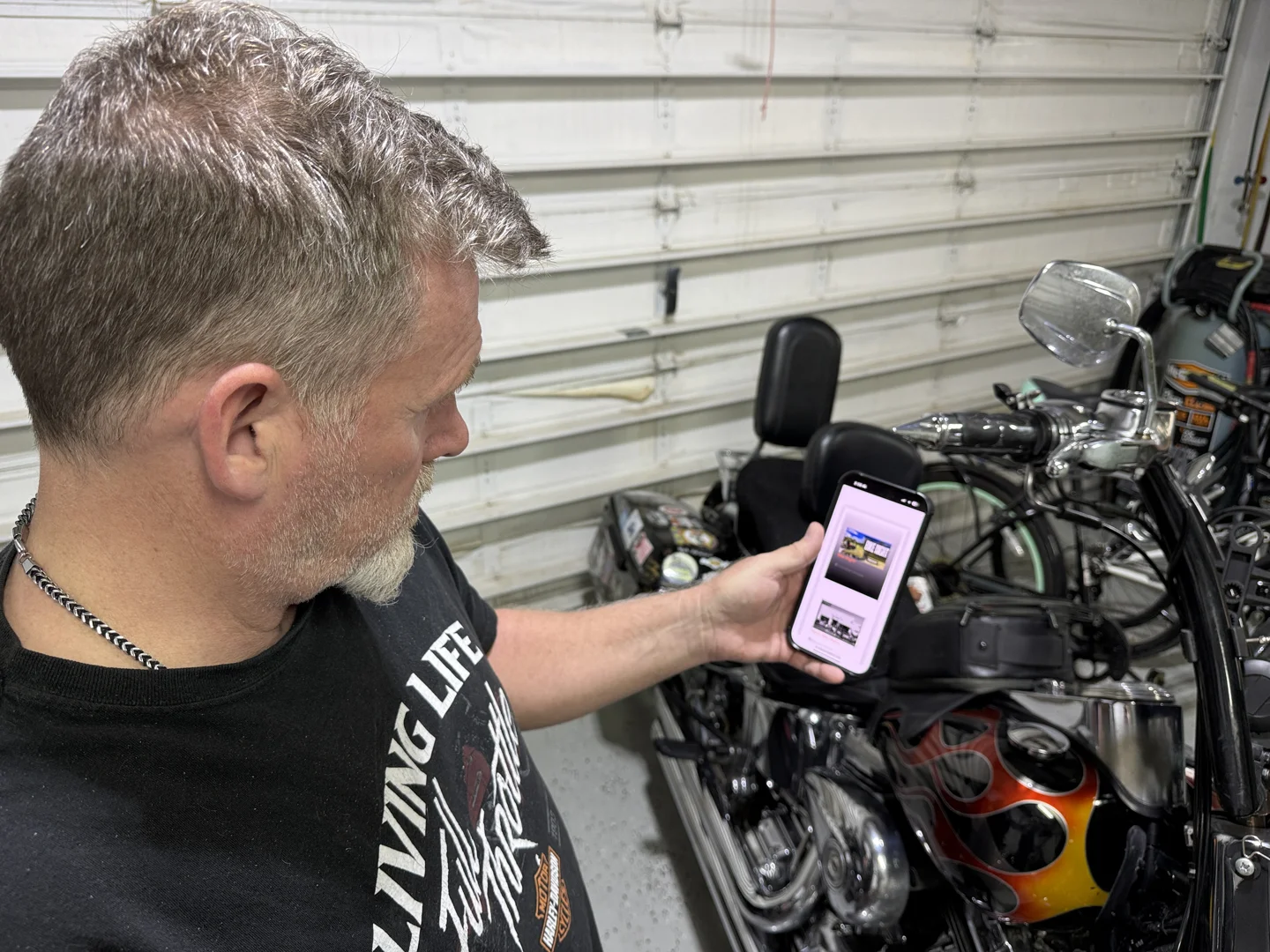 biker looking at event calendar on smartphone - motorcycle event near me biker looking at event calendar on smartphone - motorcycle event near me