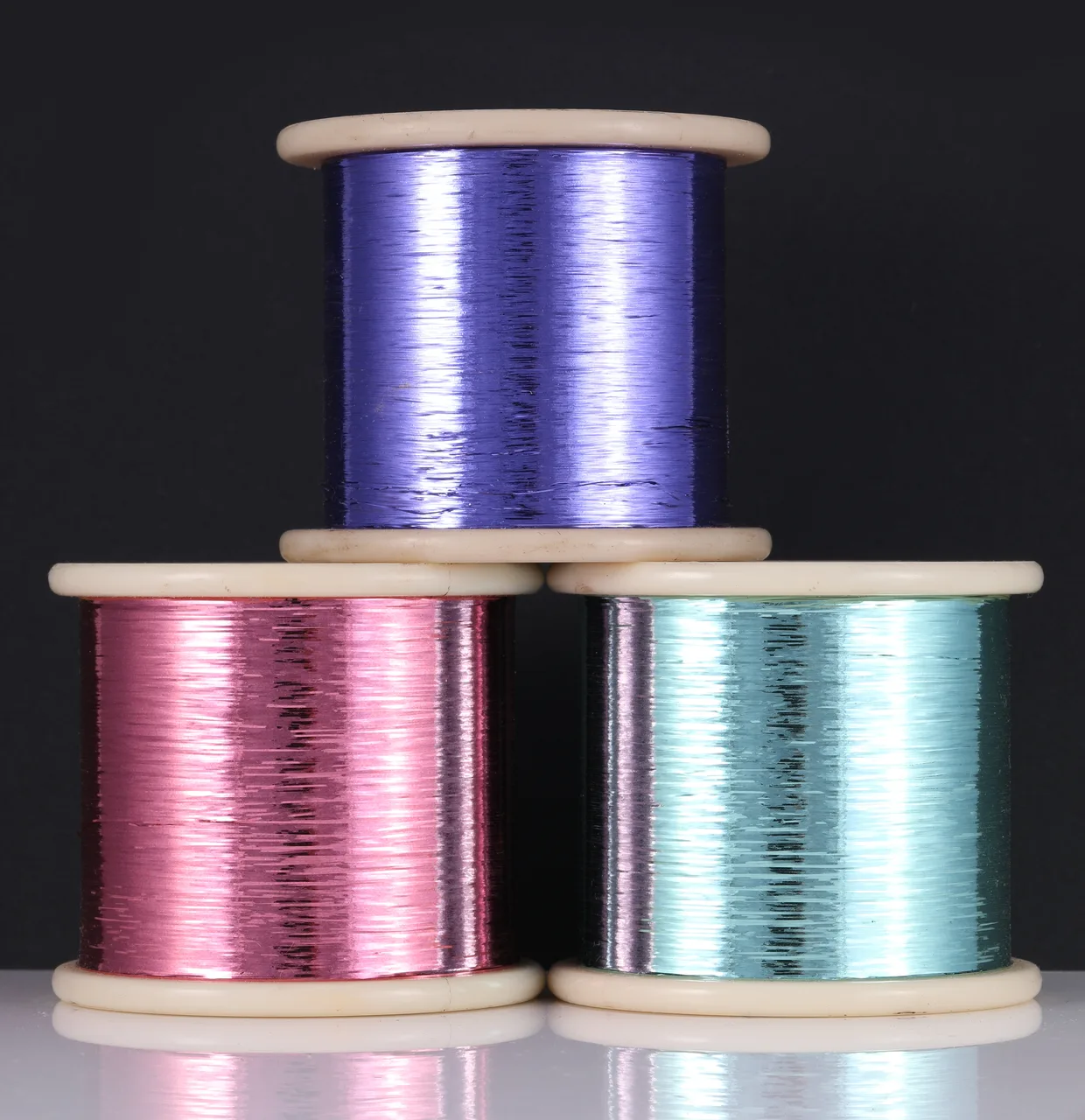 Violet, pink and aqua metallic yarn spools by Aksharlon
