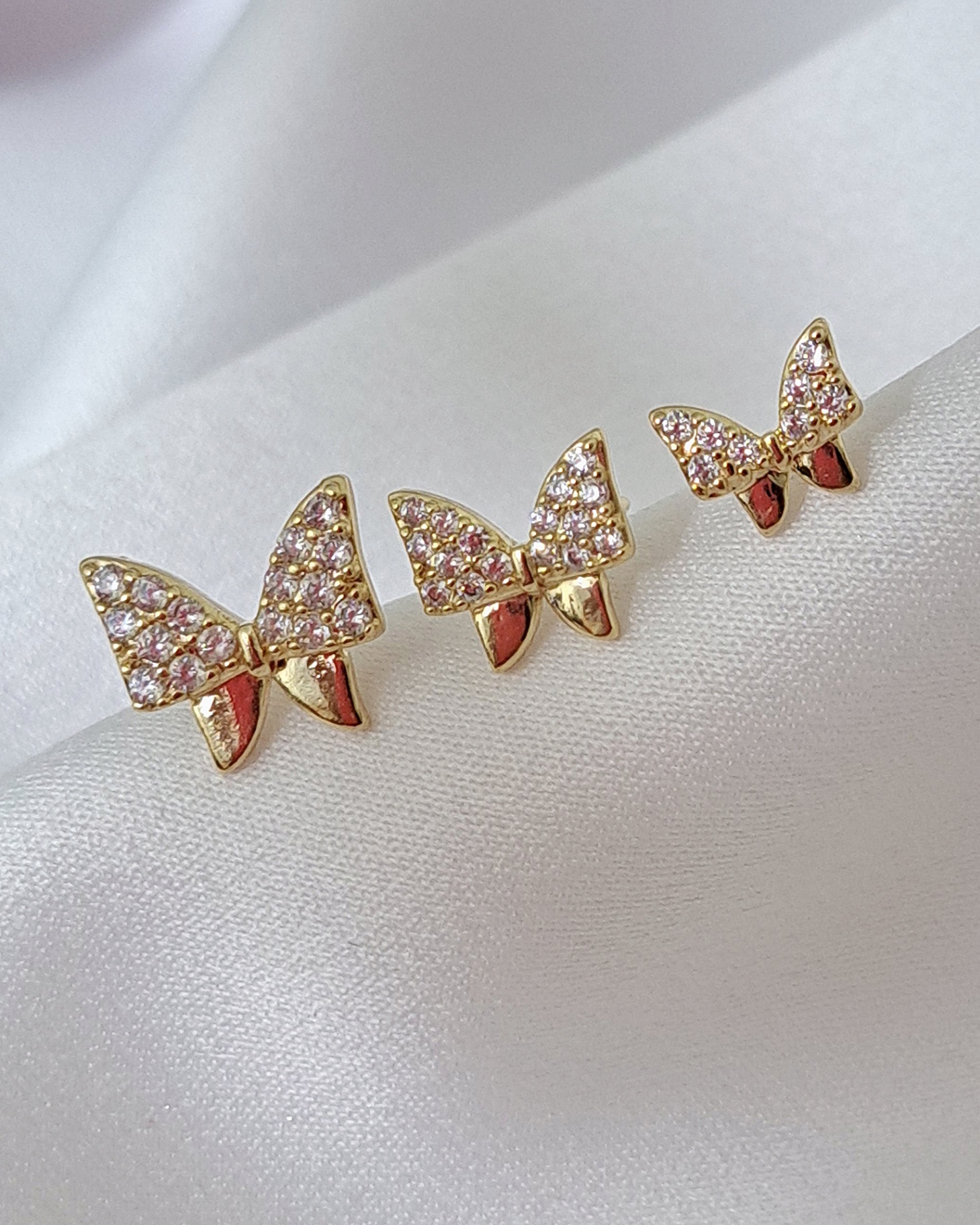 Foto de trio brinco lacinho microzircônias
