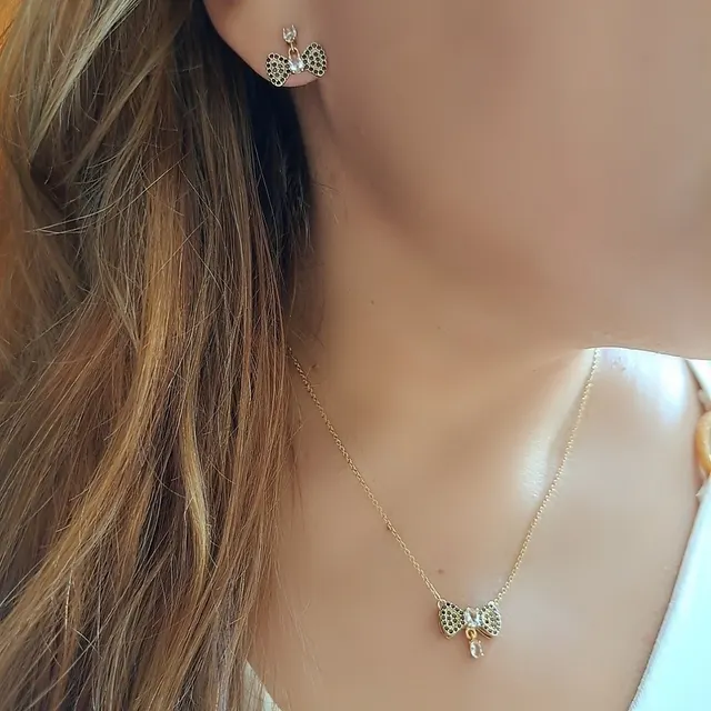 Foto de conjunto laço com microzirconias pretas e dois cristais Foto de conjunto laço com microzirconias pretas e dois cristais