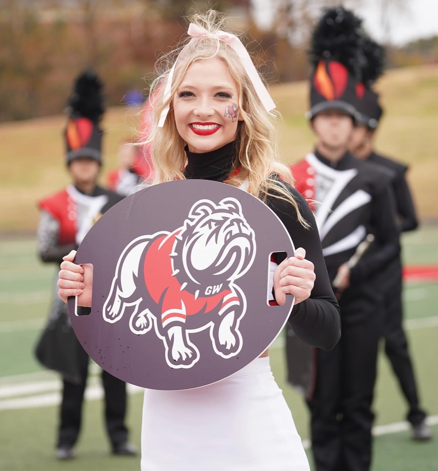 Oval cheer signs with handles for a varsity team