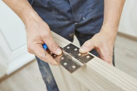 A locksmith in Birmingham repairs a door