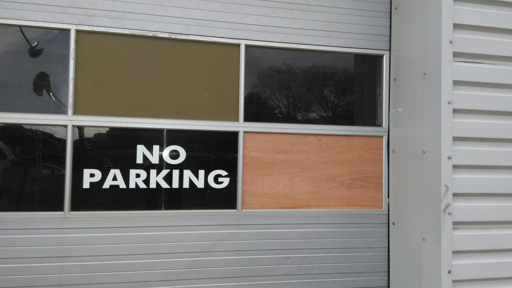 Window boarding up at car showroom