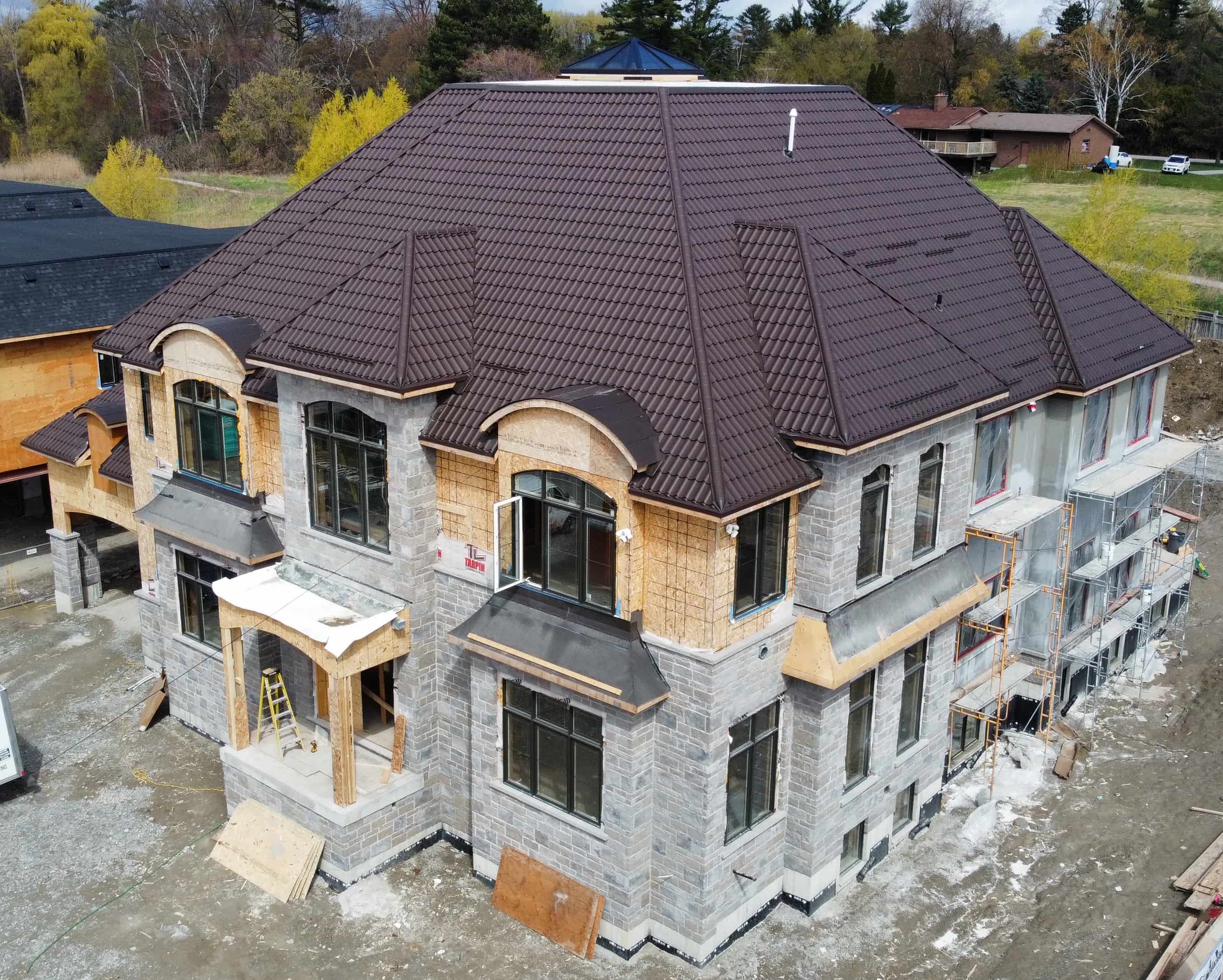 drone shot of a new custom home build with a metal roof built by ALSVICK Construction Ltd.