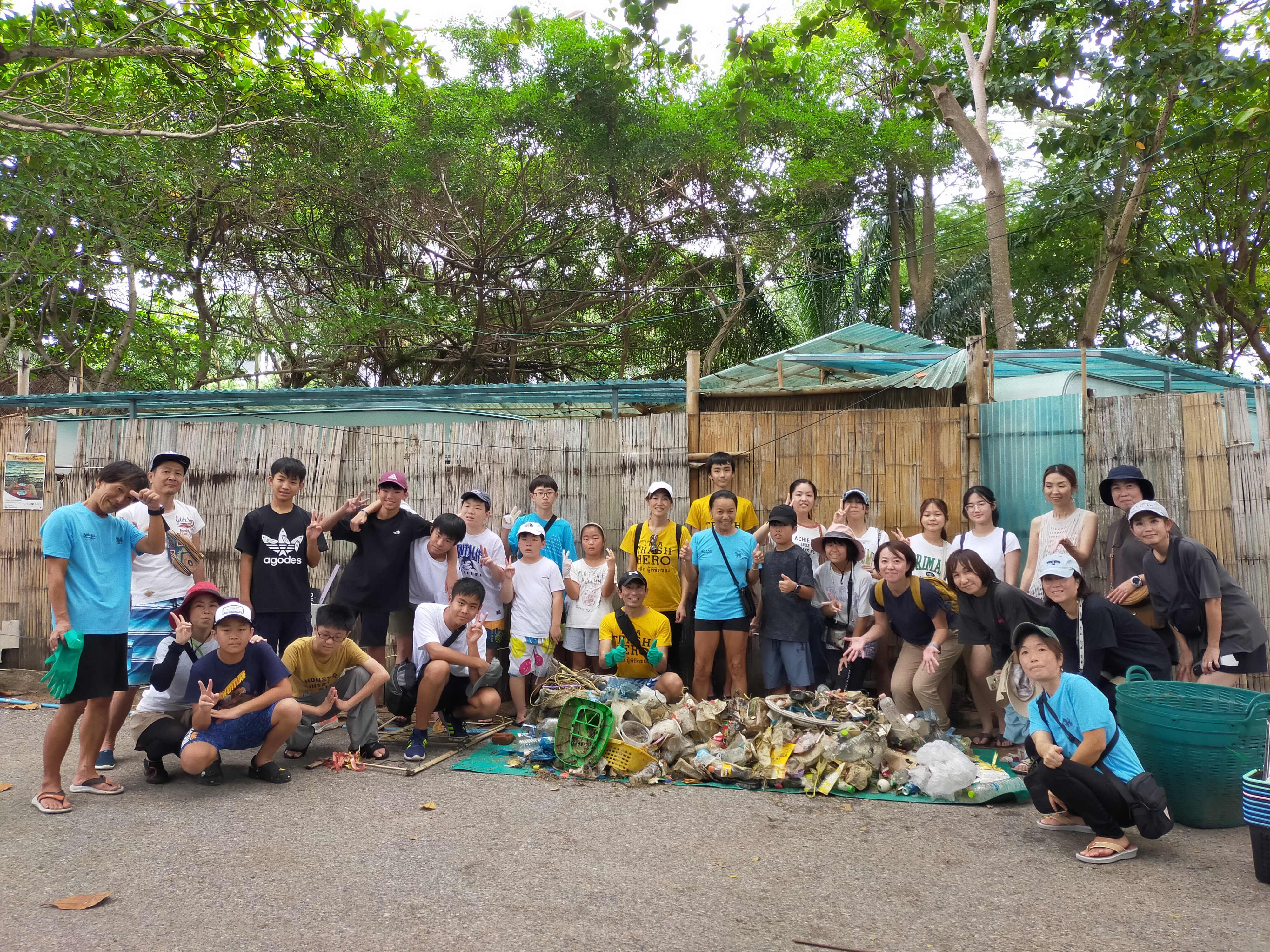 Children smiling during a beach cleanup activity
