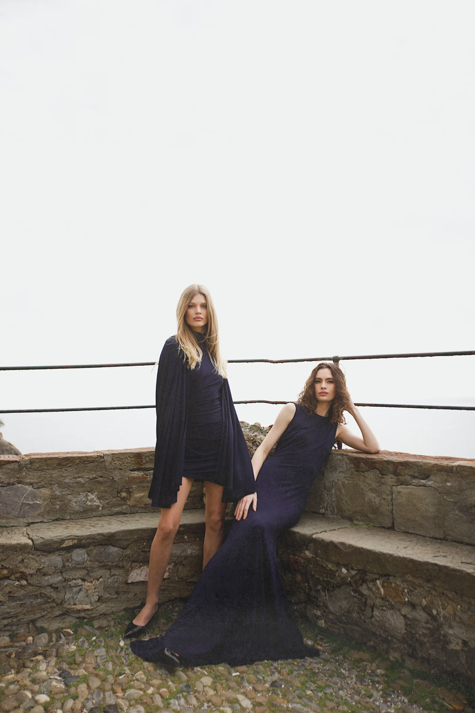 Sophisticated navy mini dress in old money aesthetic with cape 