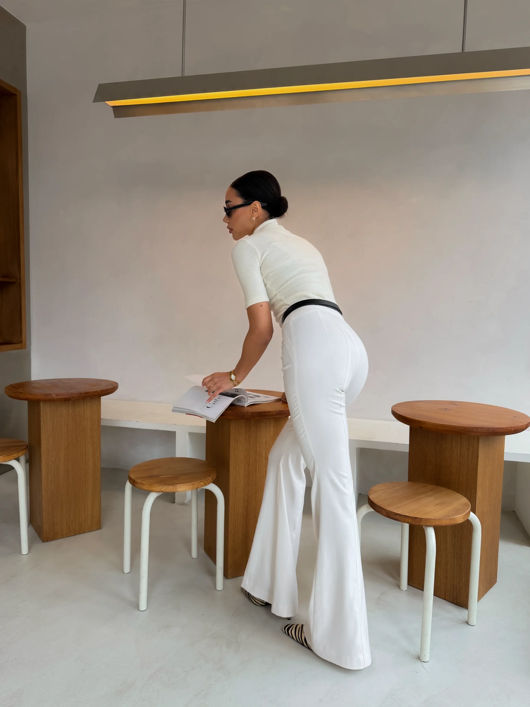 Designer white high-waisted flared Celeste trousers in quiet luxury aesthetic