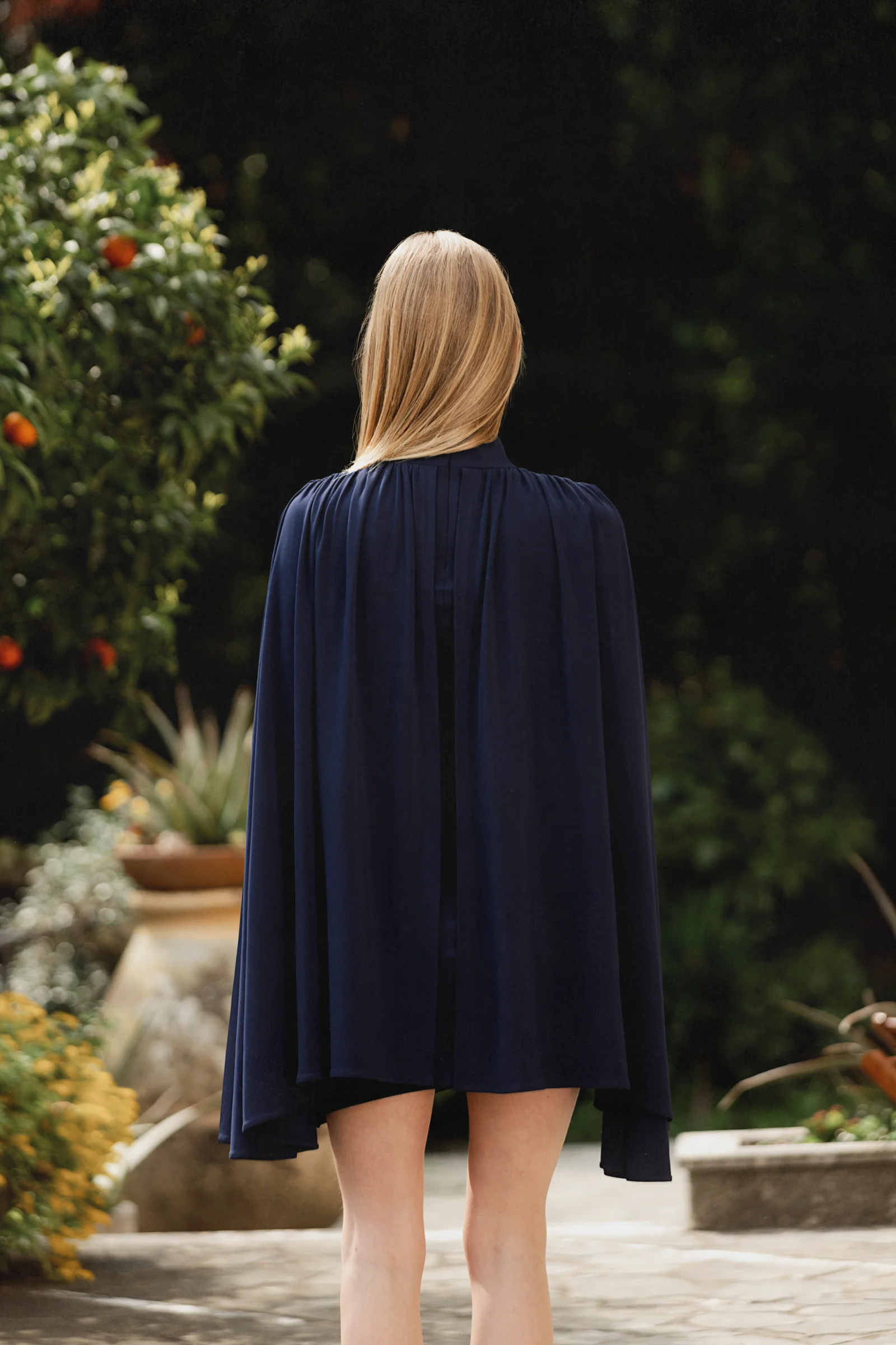 Sophisticated navy mini dress in old money aesthetic with cape 