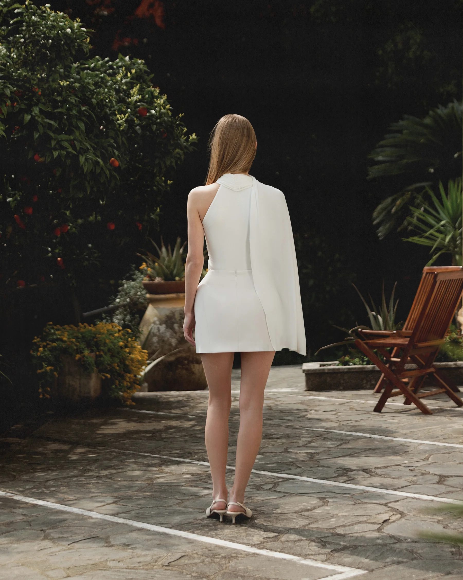 A white fitted off-the-shoulder luxury top with integrated scarf