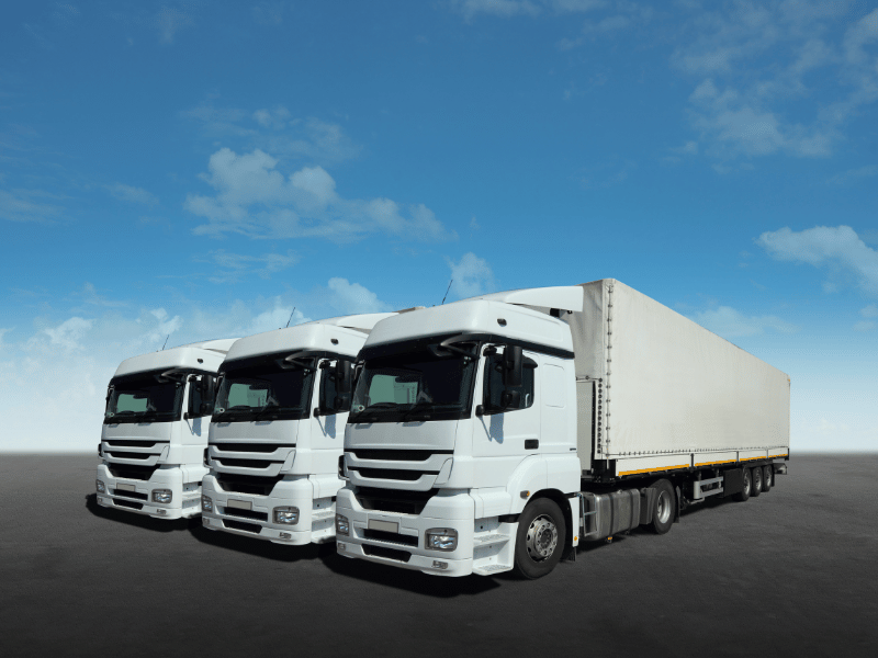 Three Ampinity electric trucks under a blue sky