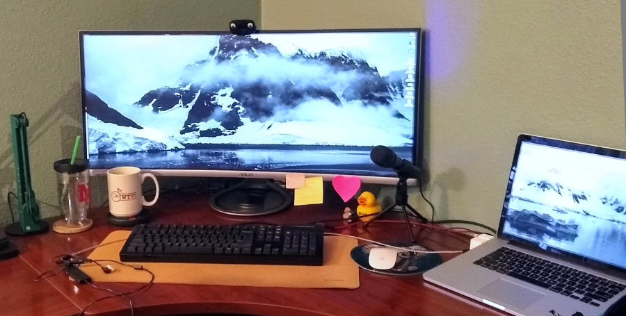 Corner desk featuring a 38 inch curved 4k display