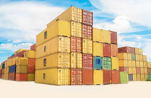 A stack of brightly colored containers in the desert.