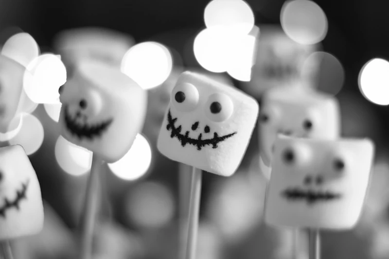 Marshmallow ghosts on a stick with drawn faces