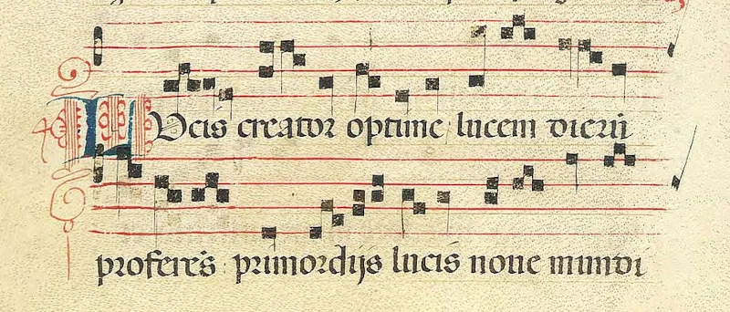 Manuscript of a Gregorian chant's sheet music with lyrics. The first word in the lyrics containing a beautifully ornate drop cap.