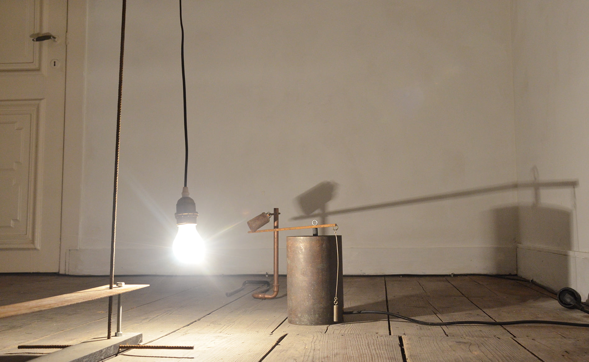 Light Bulb Hanging on a Cable, Copper Pipes and Bell| by Anna Godzina.