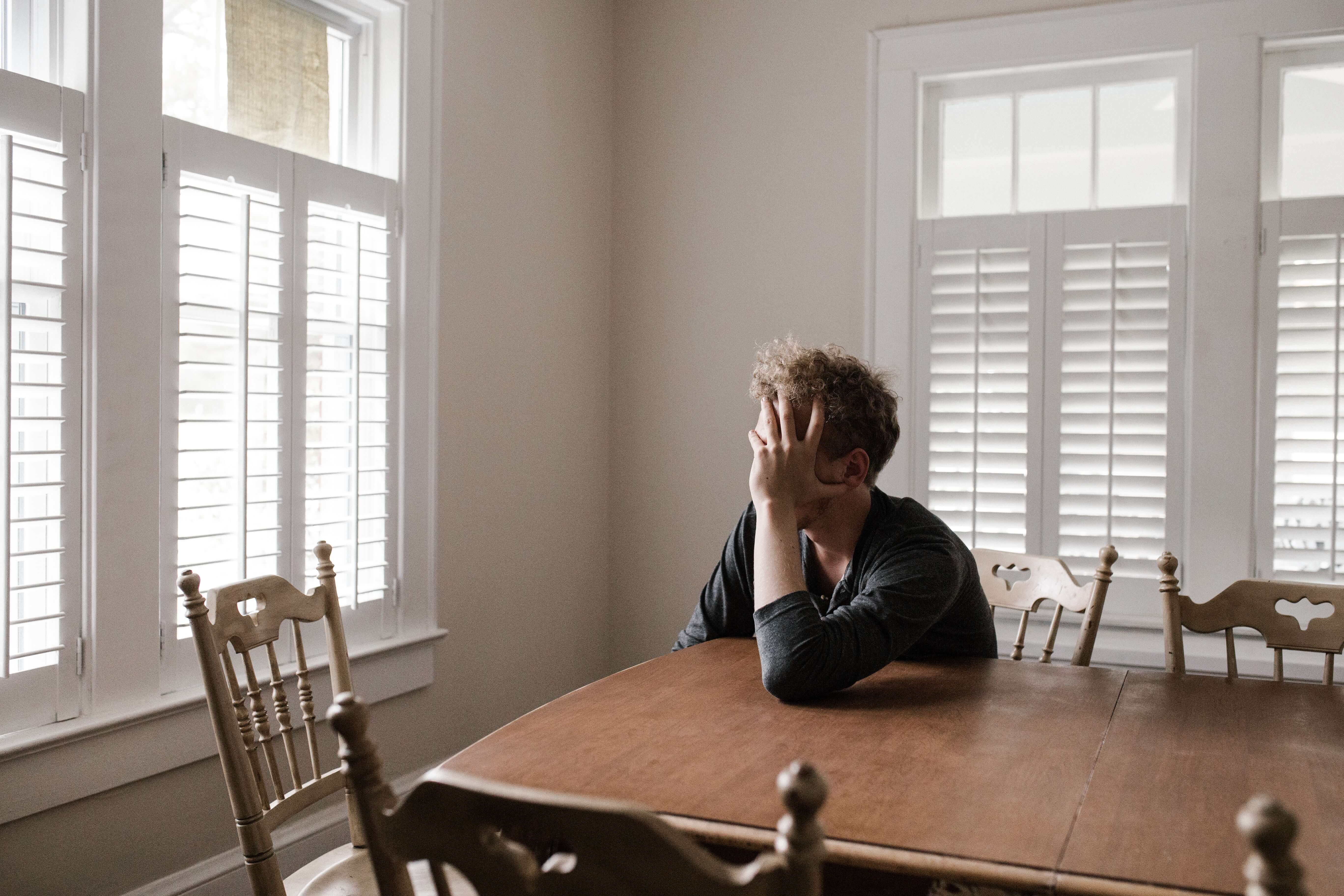 anxious man looking out of window