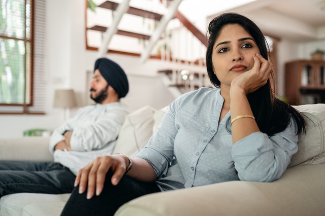 two people sitting on couch