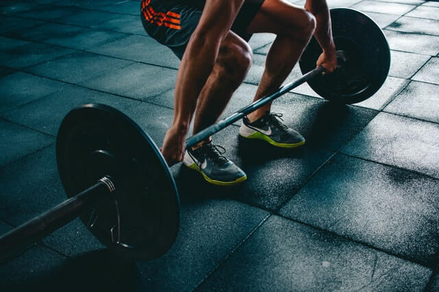 man lifting weights at the gym