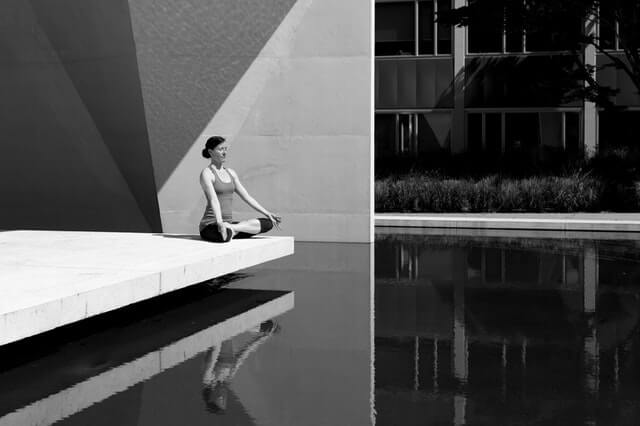 woman meditating black and white