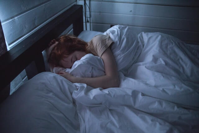 young woman sleeping in bed