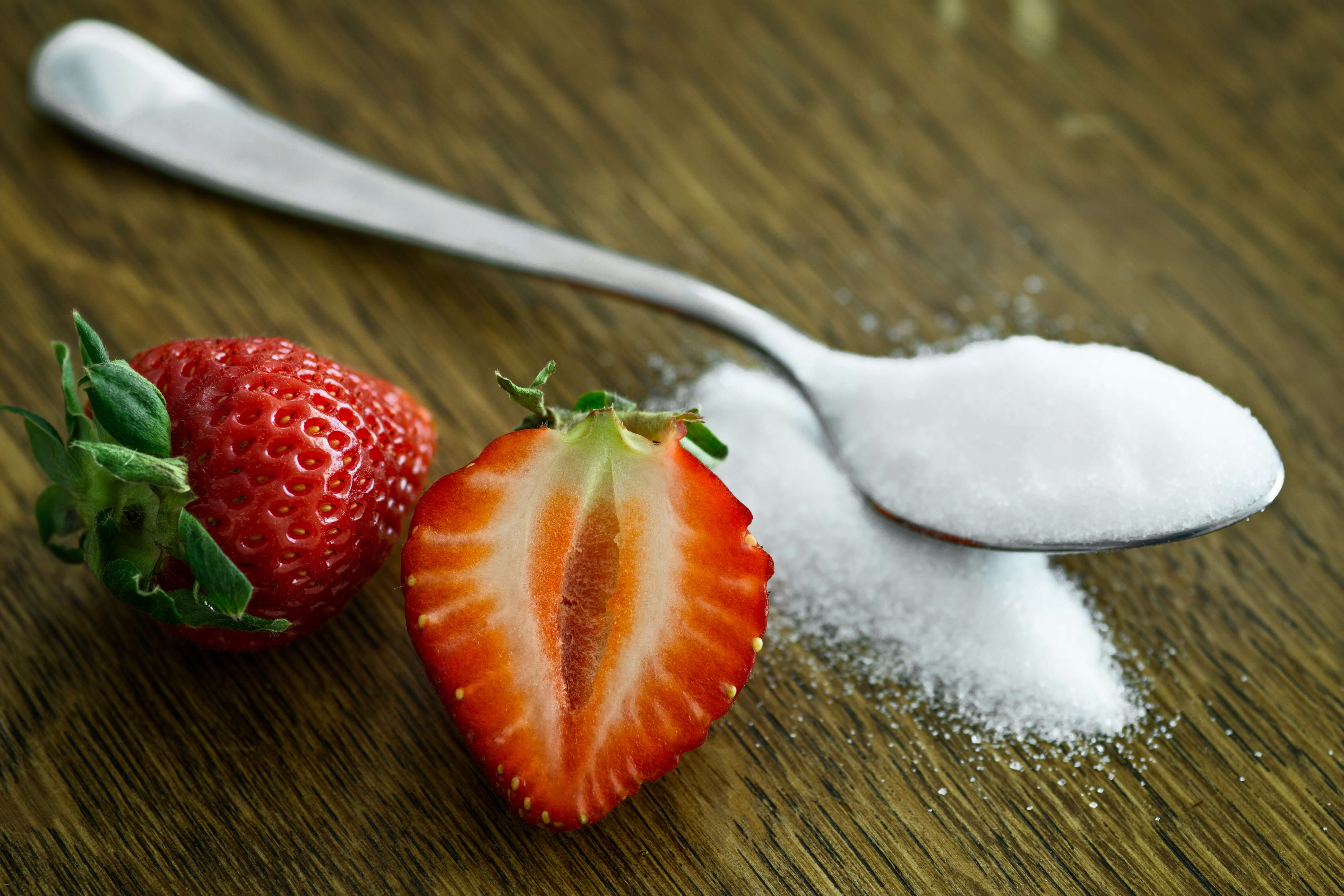 spoon with sugar and strawberries